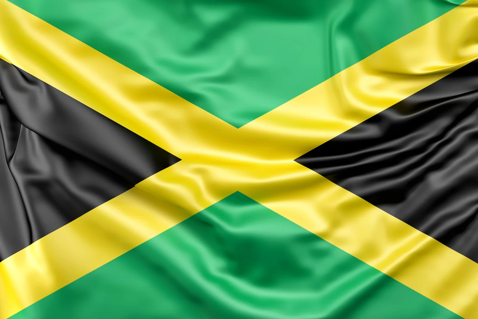 The flag of Jamaica — green, gold and black — rippling in the wind.
